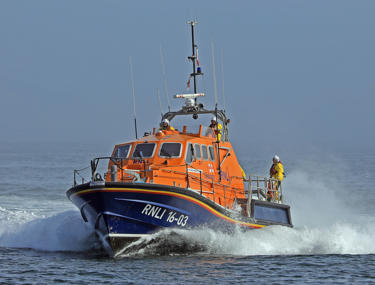RNLI boat with 3 life guards standing on deck