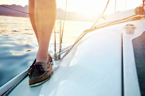 A man wearing boat shoes stood on the deck