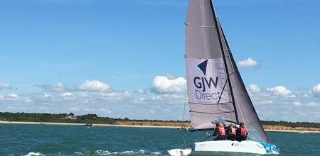 Dinghy sailing with GJW Direct Logo on sail